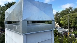 Freshly installed galvanized chase cover on a barrier-island home near Bradenton Beach