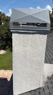 New galvanized diamond-style chimney cap on a stucco chase near Bradenton Beach