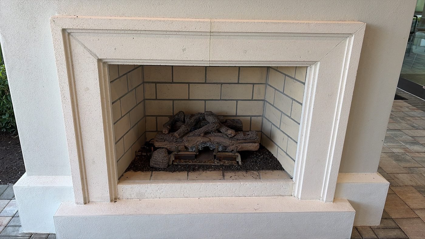 Gas fireplace with stone surround and gas logs at a Jacksonville-area home