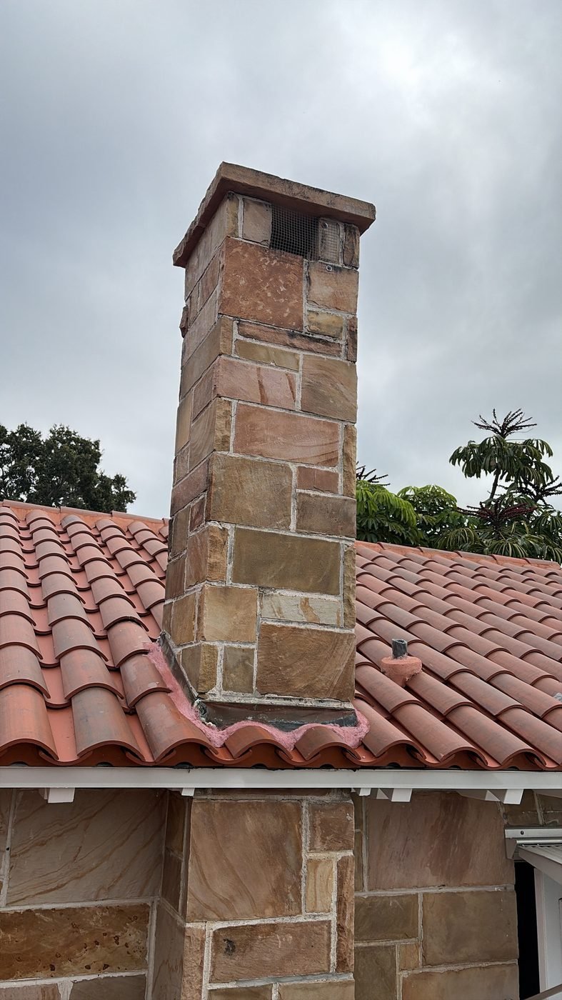 Tall stone chimney with a tile roof, typical of older individually built Jacksonville-area homes